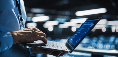 man holding laptop with stock graphic