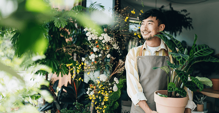 young man holding plant