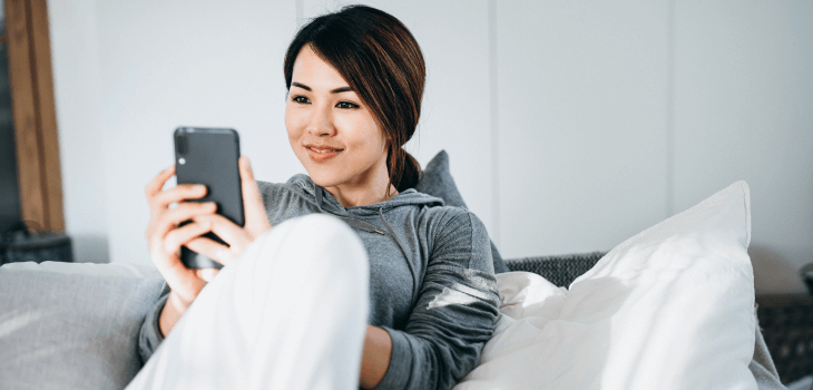 Woman checking ECN fees on her phone
