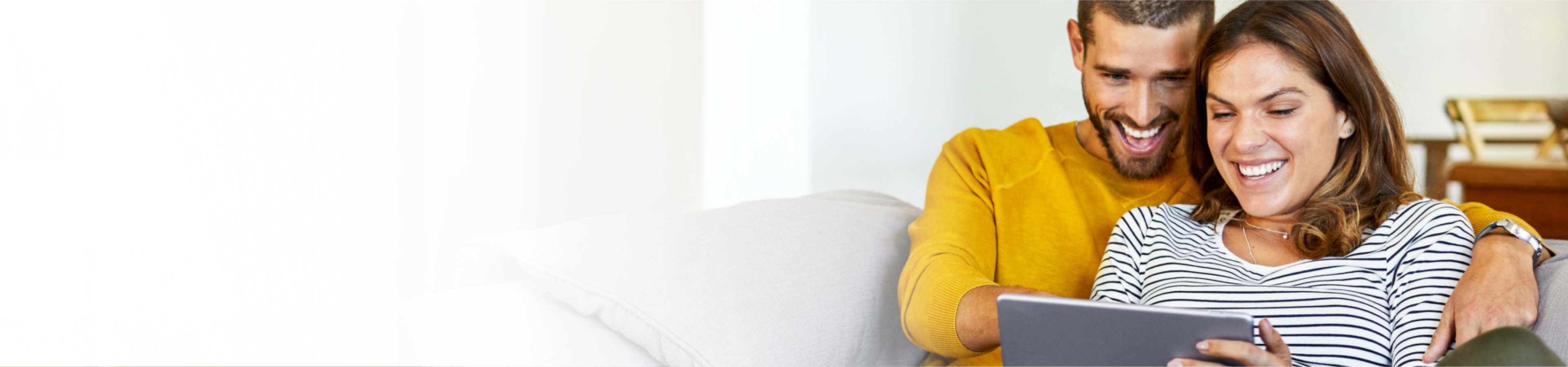 Couple smiling looking at laptop