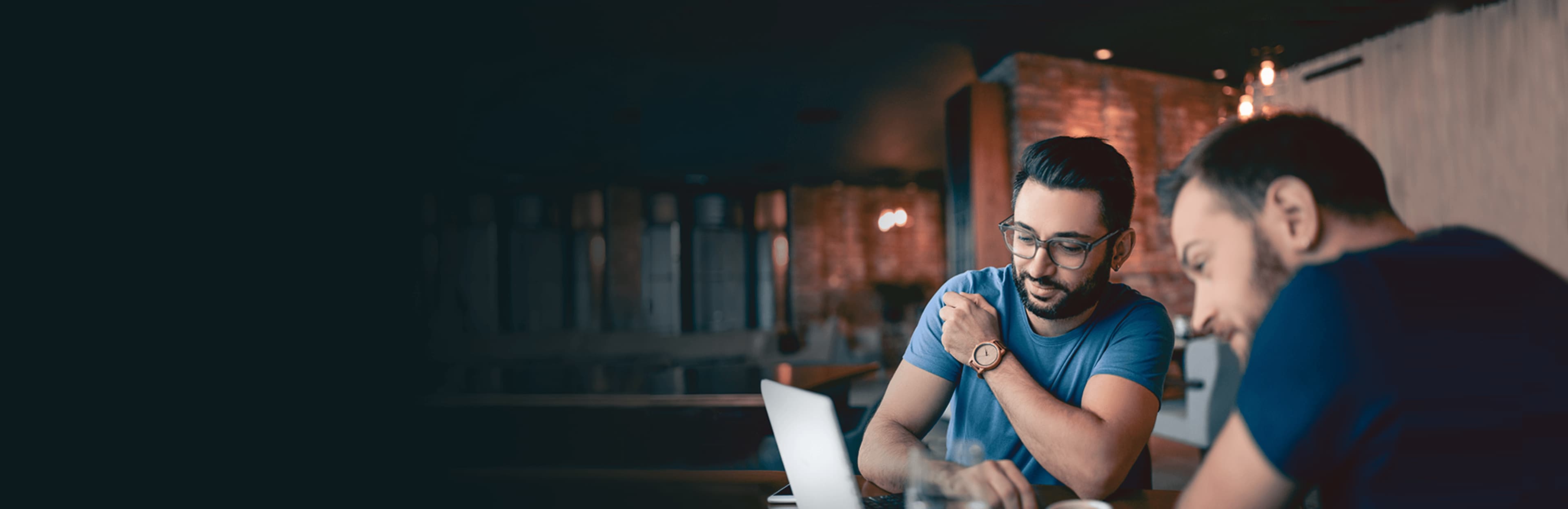 Men reviewing Questrade on their laptop