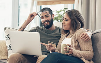 Couple using laptop
                        