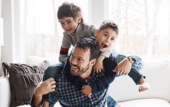 Father playing with
                        children 