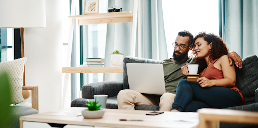 Couple checking their laptop to see mortgage rates