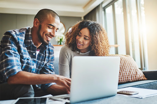 Couple checking homes on their laptop