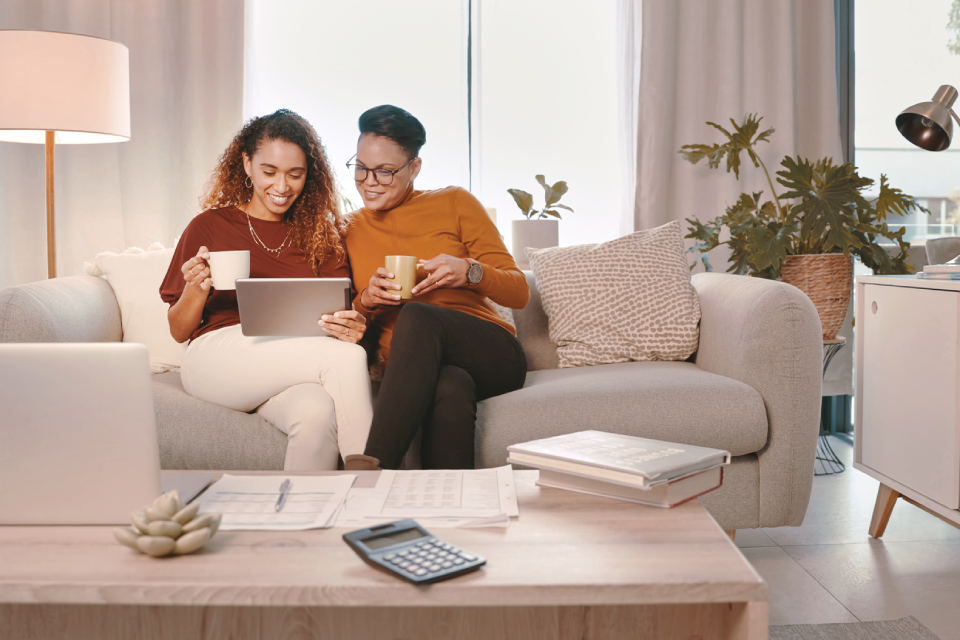 Two ladies looking at a tablet for a mortgage application